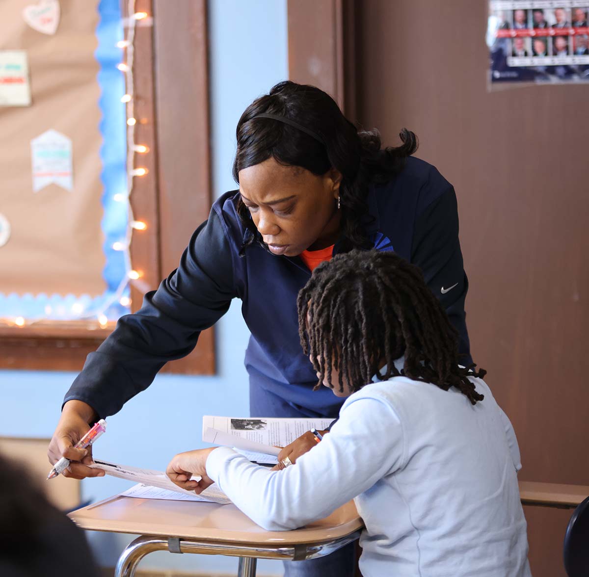 Horizon Science Academy Denison Teacher and student interacting at a classroom desk